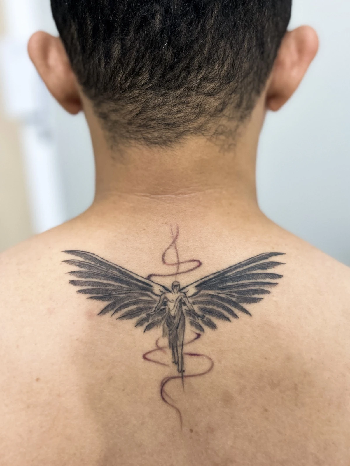 Tattoo figur bersayap di tengkuk · Meigu Tattoo